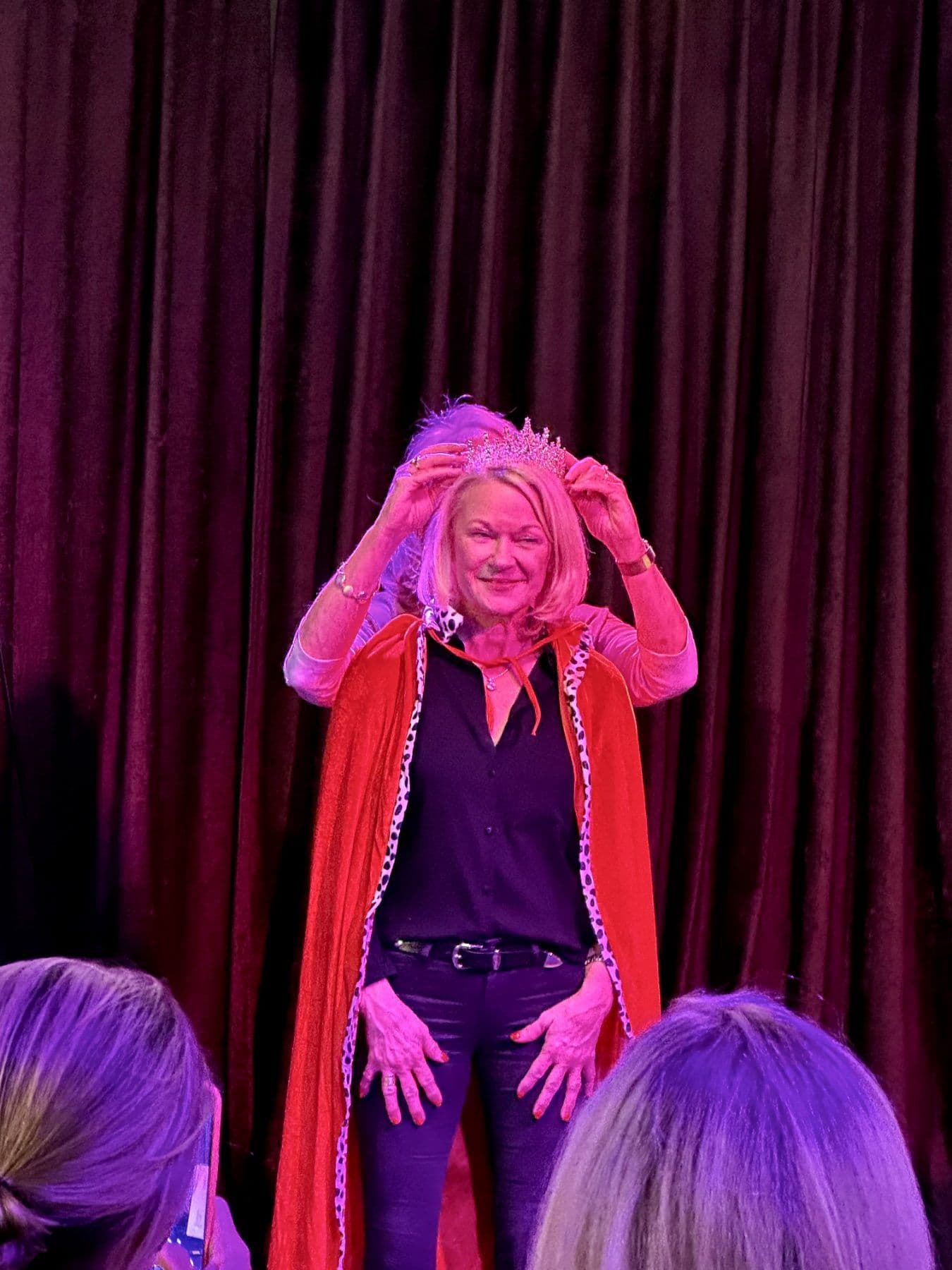 The tournament winner is crowned with a tiara and red cape on stage
